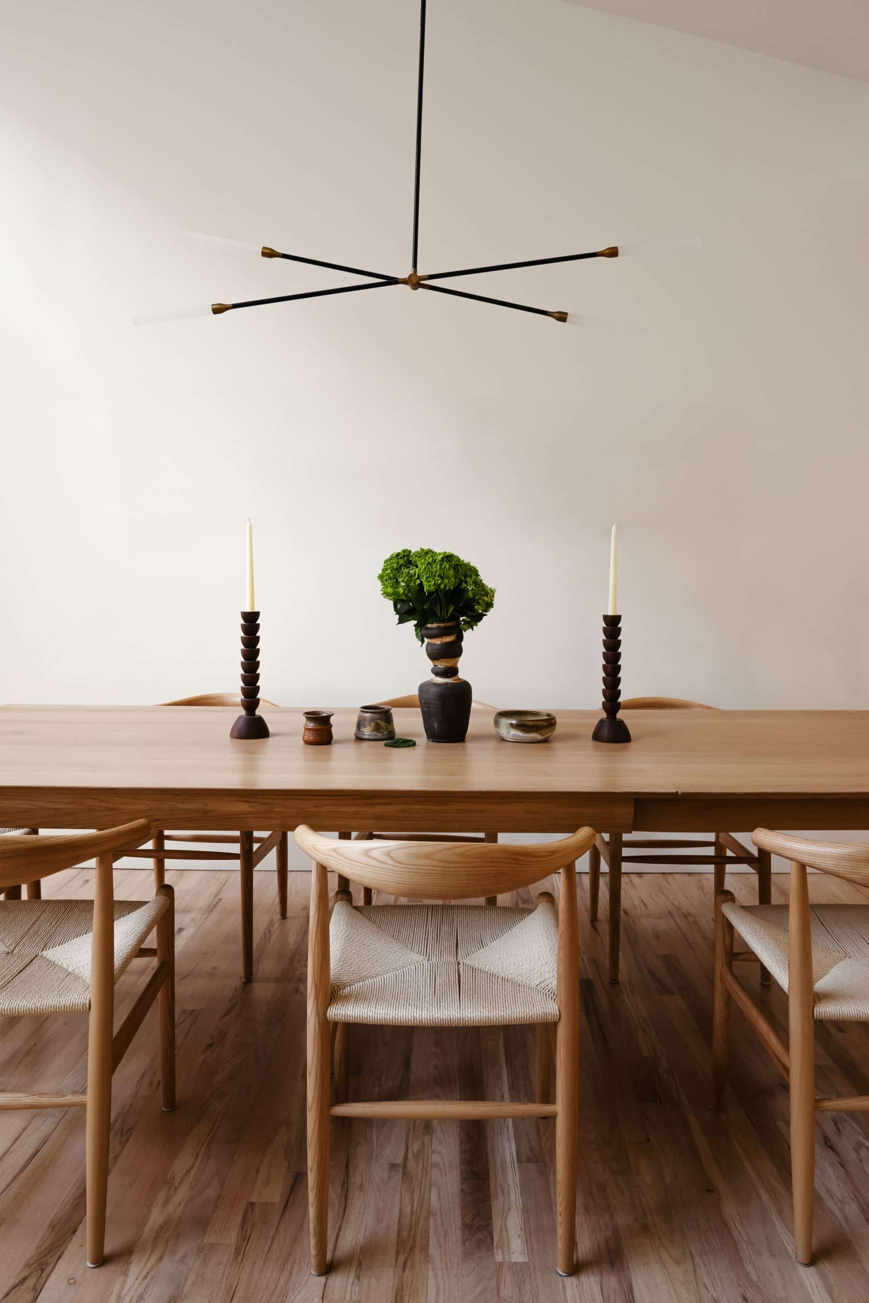 Dining table centered beneath a pendant light