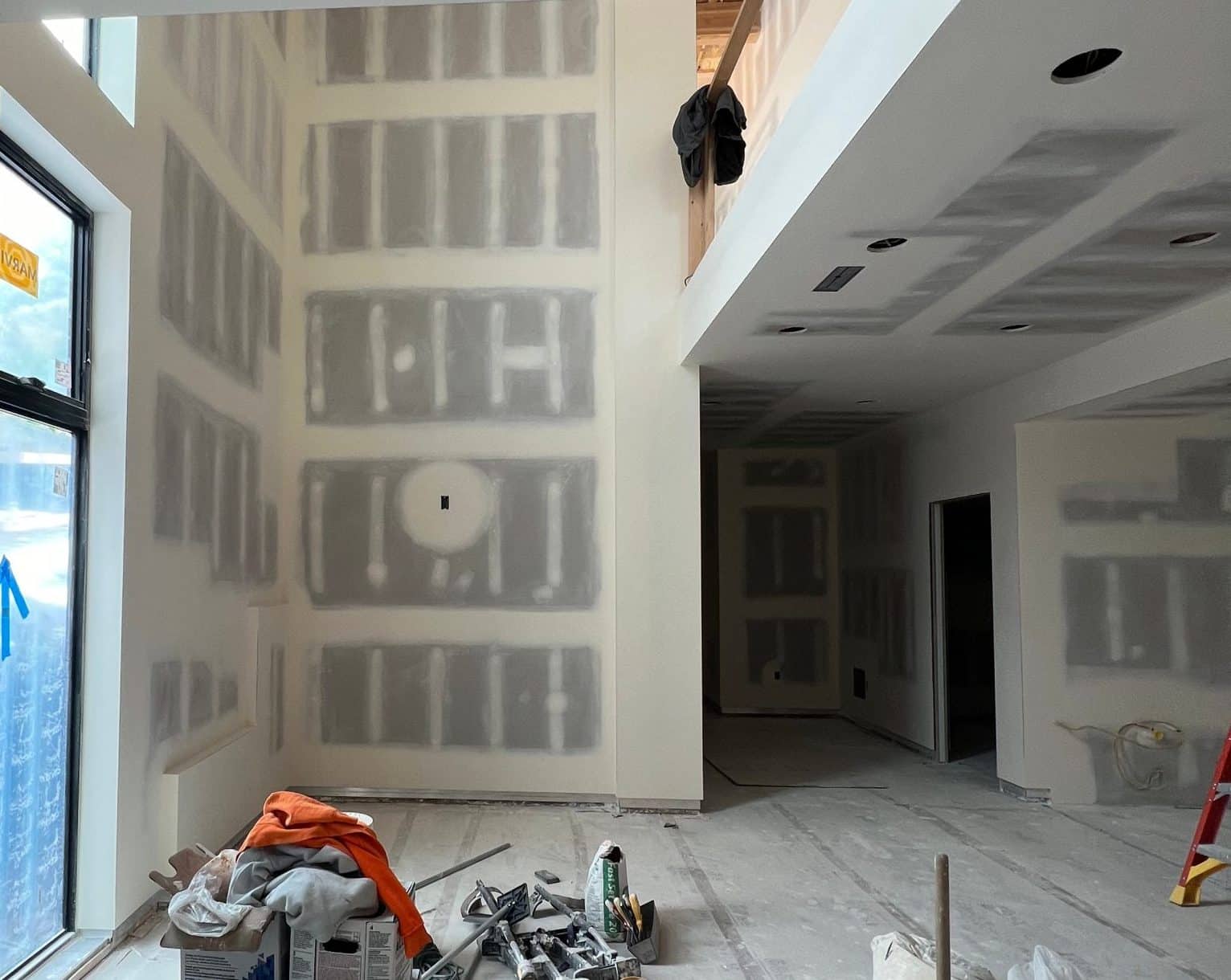 The residence during construction, with taped drywall and an unfinished double-height great room