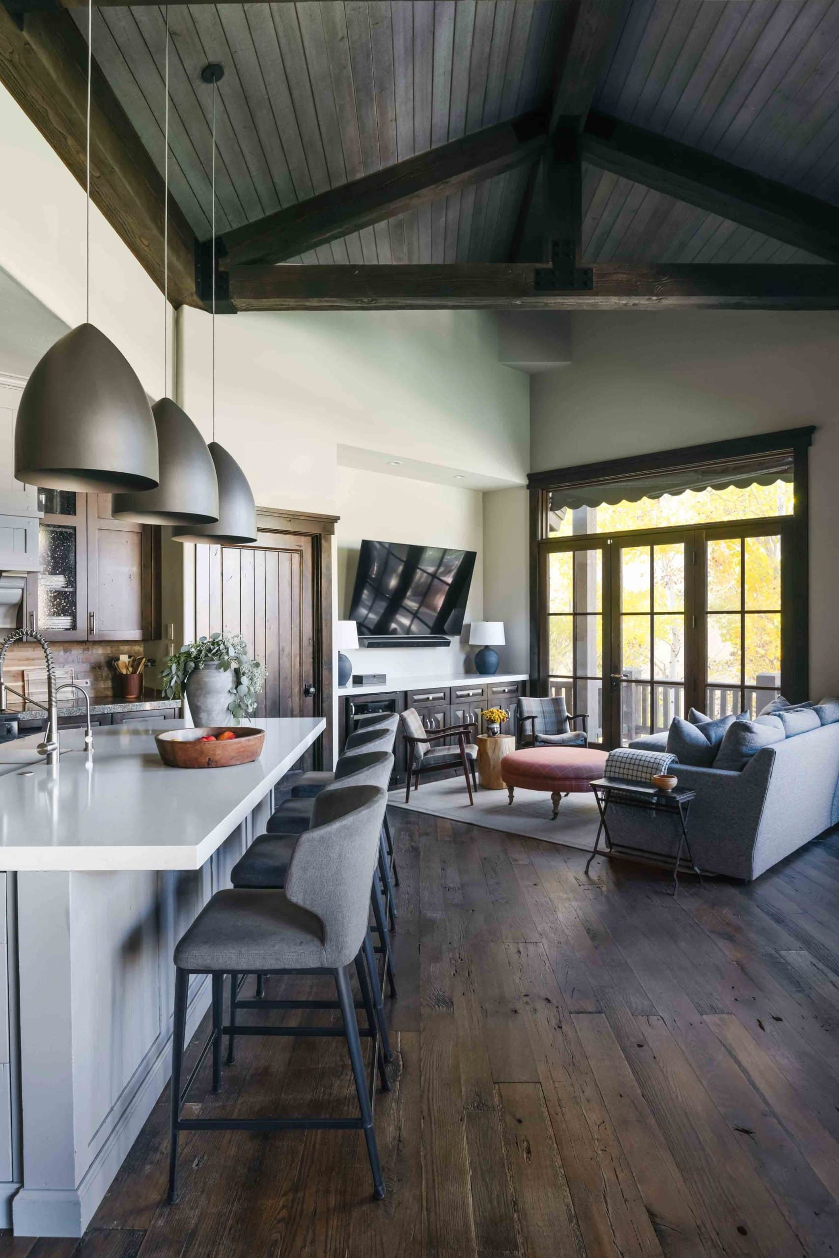 Open kitchen and TV space with an island, counter seating, and a comfortable lounge area