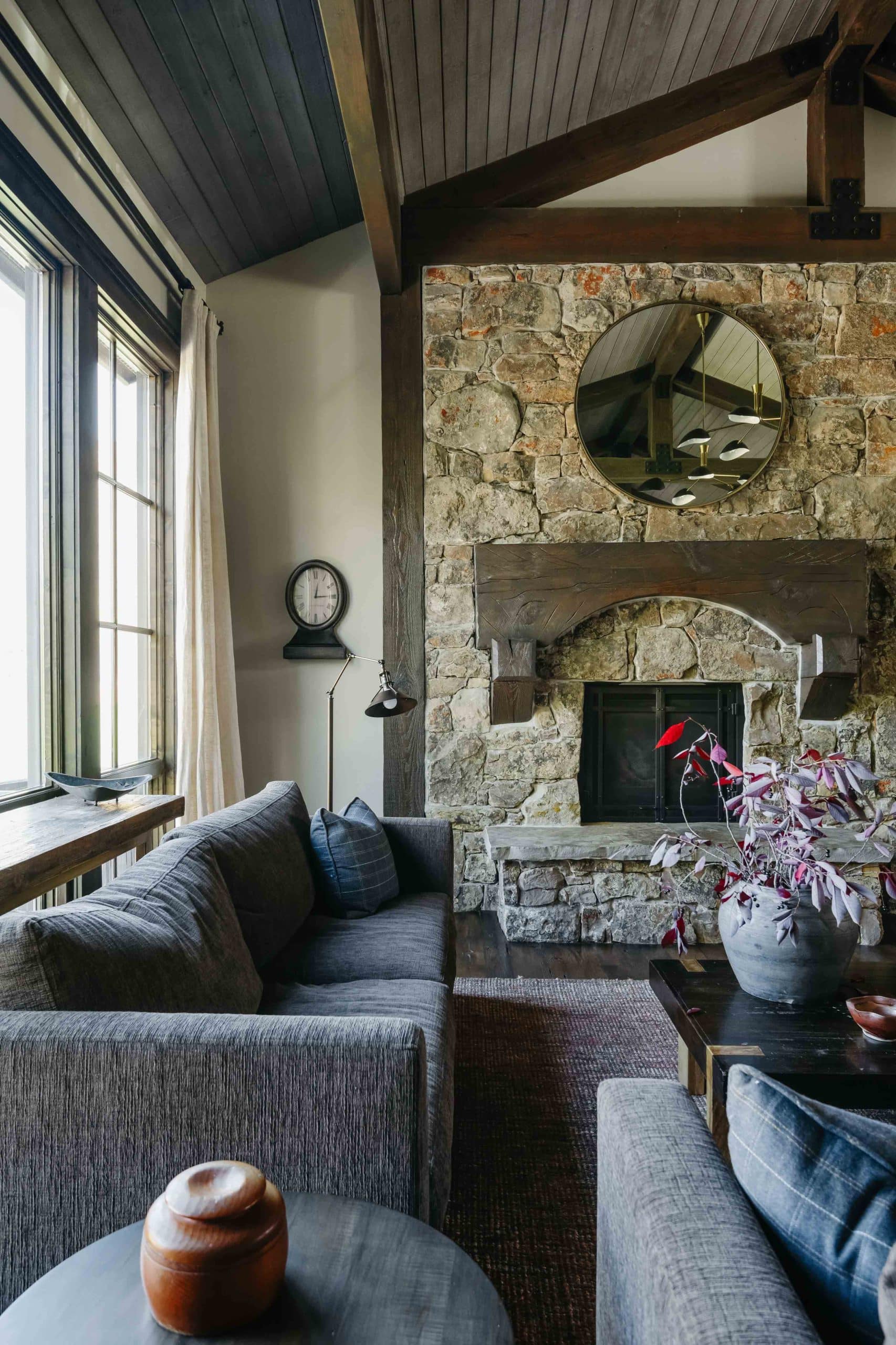 Living room detail with textured upholstery, throw pillows, and a natural-wood side table