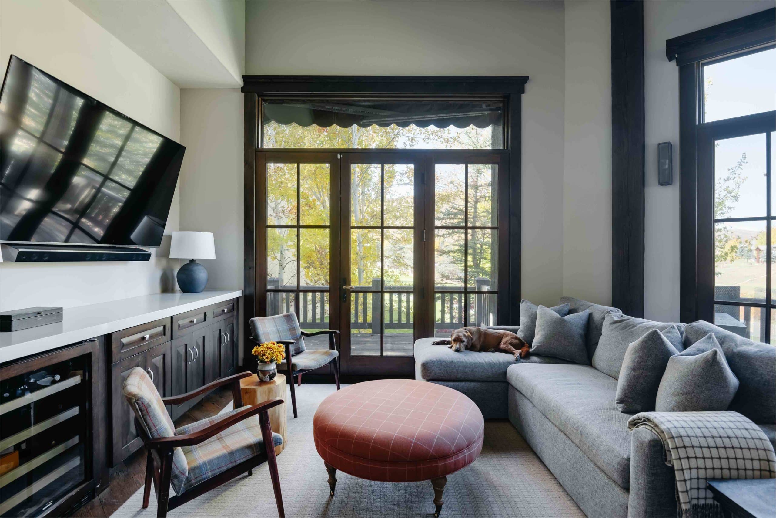 Upstairs TV room with a sectional sofa, media wall, and soft mood lighting