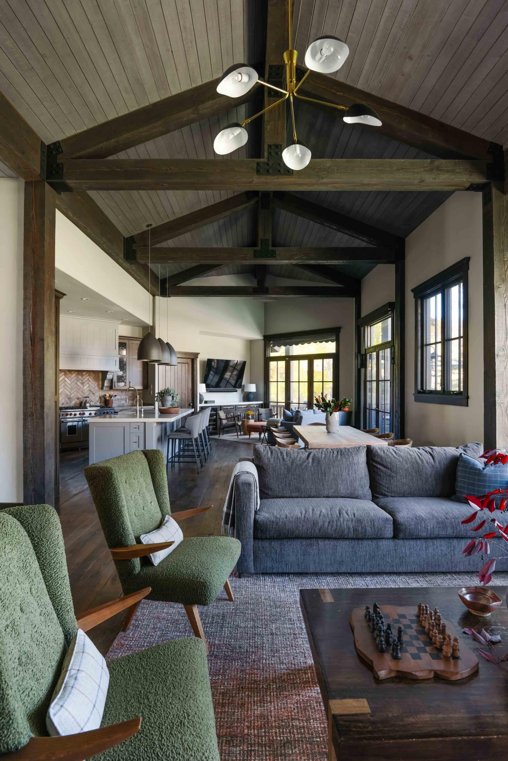 Upstairs living room with a large sectional, area rug, and mountain views through the windows